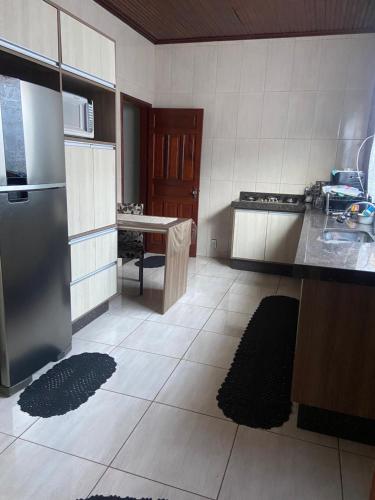 a kitchen with a refrigerator and a table in it at Casa de Andirá in Andirá