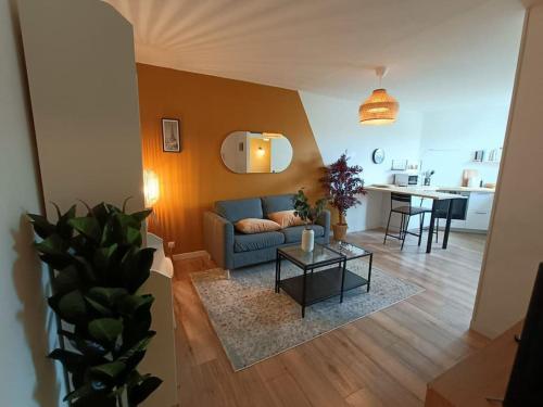 a living room with a couch and a table at Le Yellow Corner - Place Ney in Angers