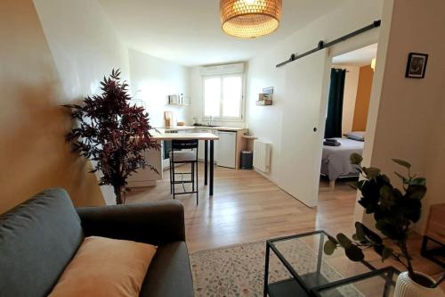a living room with a couch and a table at Le Yellow Corner - Place Ney in Angers