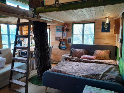 a bedroom with a bunk bed in a tiny house at Tree house Ramona & Fairytale wooden house by Ljubljana in Grosuplje