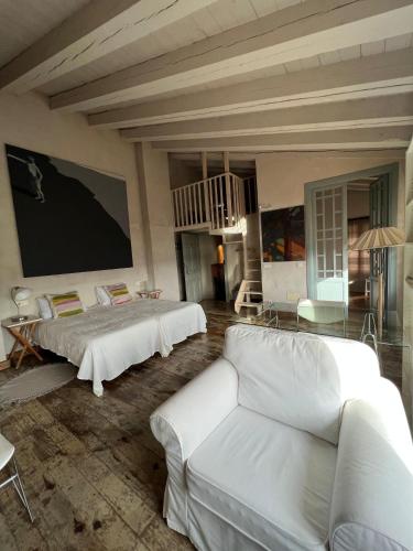 a living room with two beds and a couch at Casa Rural La Chocolateria in Horche