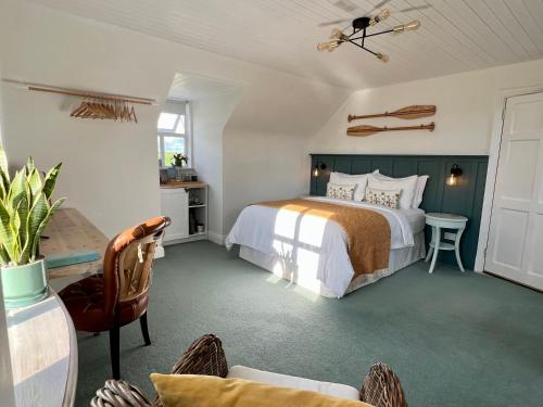 a bedroom with a bed and a table and a chair at Thistledown Lodge in Fethard on Sea