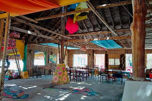 a large room with tables and chairs in it at Chaba Bungalows in Ban Ai Dao