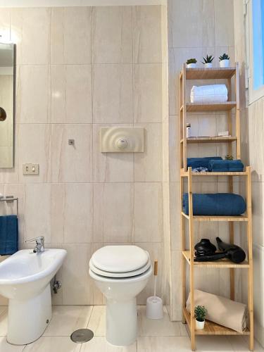 a bathroom with a toilet and a sink at Apartment San Valentino in Rome