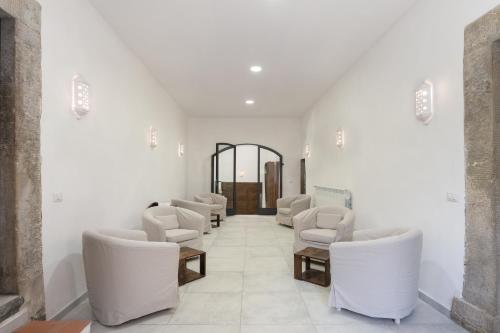 a waiting room with white chairs and a mirror at Villa Eugenia Tuscany with private Pool, Sauna & Gym in Vicchio
