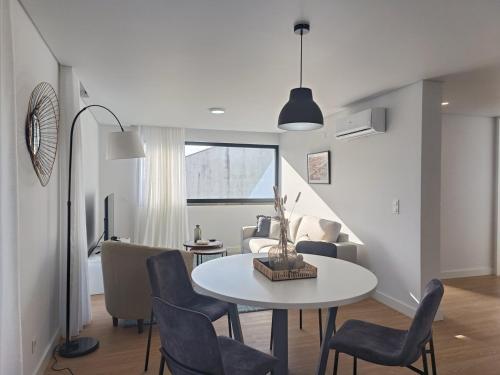 a living room with a table and chairs at Casa Urban Coastal - City Center in Ponta Delgada
