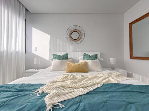 a bedroom with a large bed with a blanket on it at Casa Urban Coastal - City Center in Ponta Delgada