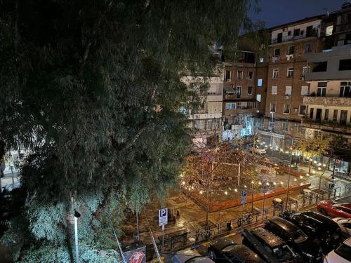 a view of a parking lot in a city at night at Boutique Flat in the City Center in Tirana