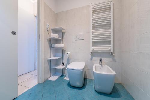a bathroom with a toilet and a sink at Cosenz Charme Apartment in Milan