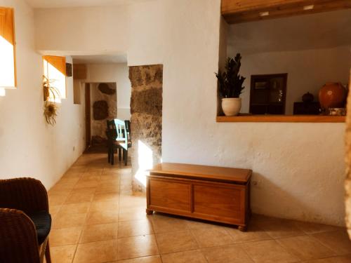 a living room with a table in a room at Casas cuevas, Los Cabucos in Agaete