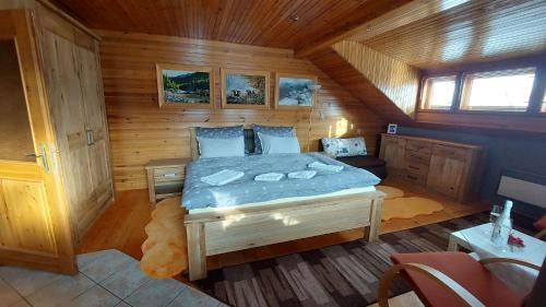 a bedroom with a bed in a wooden cabin at Privát Prima in Liptovský Ján
