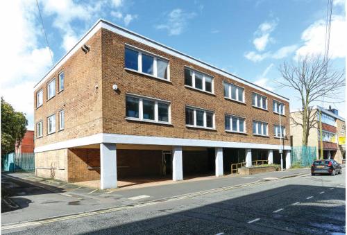 a large brick building on the side of a street at Urban 2 Bedroom with Parking in West Bromwich