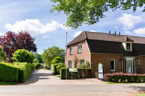 a brick house with a sign in front of it at Summio Vakantiepark De Riethorst in Plasmolen