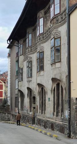 an old building with a person standing in front of it at Fadilpasic's House in Sarajevo