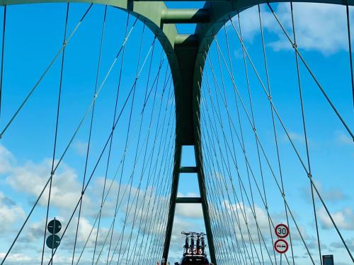 a bridge with a blue sky in the background at Kajüthus Apartment 1 in Fehmarn