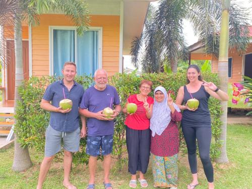 a group of people standing in front of a house at Baan Kebsap บ้านเก็บทรัพย์ in Ko Yao Noi