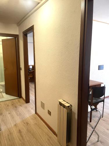 Cette chambre dispose d'une porte et d'une table avec une chaise. dans l'établissement HOTEL DU SOLEIL, à Torgnon
