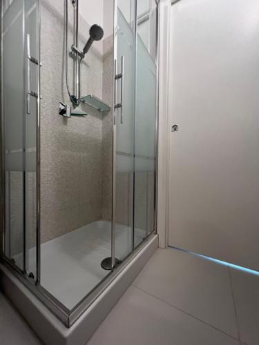 a shower with a glass door in a bathroom at Da Carlin in Cesena