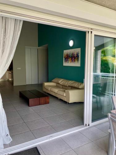 a living room with a couch and a table at chez Gérald in Noumea