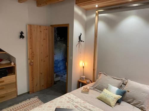 a bedroom with a bed and a door to a closet at WAKA PICO AZORES in São Roque do Pico