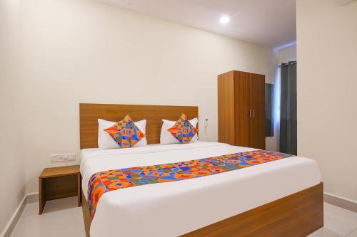 a bedroom with a large bed in a room at FabHotel Air Live in Hyderabad