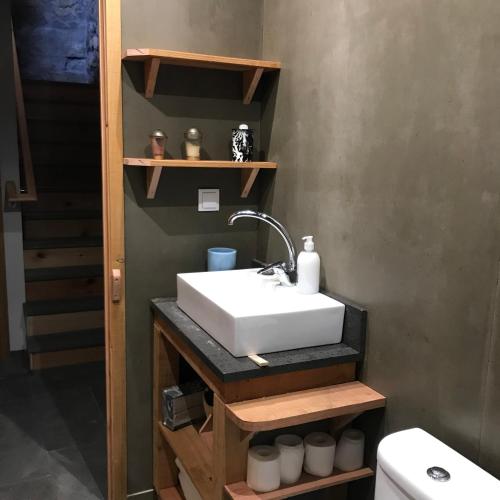a bathroom with a sink and a toilet at Waka Sun Set PICO AZORES in São Roque do Pico
