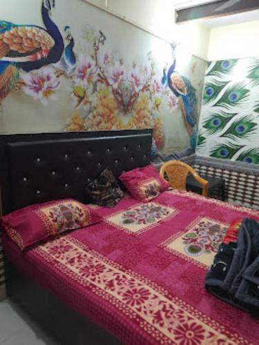 a bedroom with a bed with a pink comforter at Hotel Rajdarbar Fatehpur in Fatehpur Sīkri