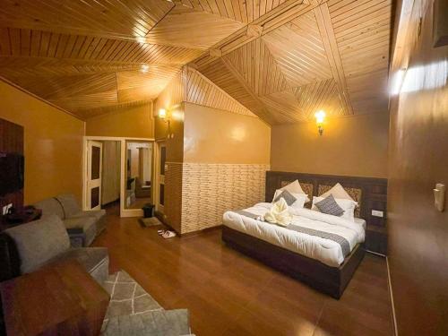 a bedroom with a large bed in a room at Uptown Boutique Homes - Room 1 in Shimla