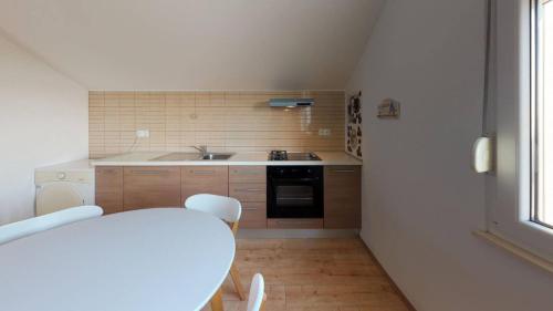 a small kitchen with a table and a sink at XXL Luxury villa near Split for up to 16 people in Kaštela