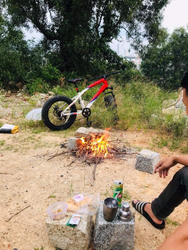a dirt bike parked next to a camp fire at Homestay Tuyết Trinh in Nha Trang