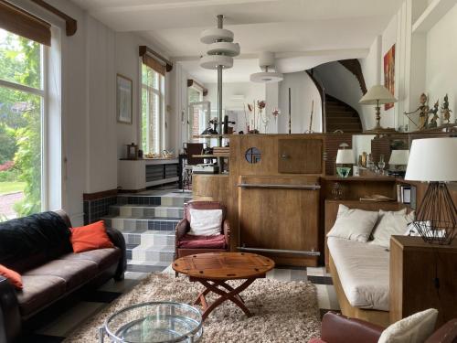a living room with couches and a table at Petite Source in Varengeville-sur-Mer