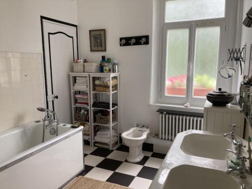 a bathroom with two sinks and a tub and a toilet at Petite Source in Varengeville-sur-Mer