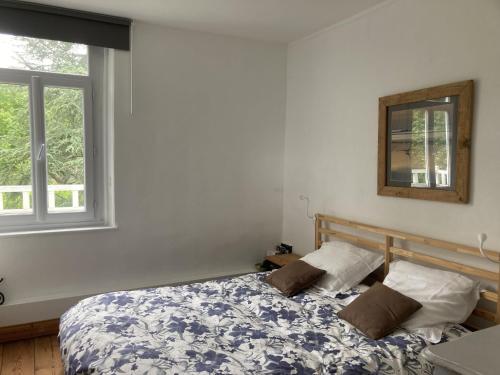 a bedroom with a bed and a window at Petite Source in Varengeville-sur-Mer