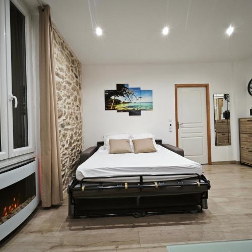 une chambre avec un lit et une cheminée dans l'établissement Appartement tout confort à 2 pas du centre ville, à Aubagne
