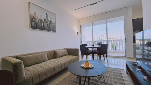 a living room with a couch and a table at STAY Cosmo City Suites in Nicosia