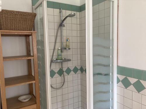 a shower with a shower head in a bathroom at Maison des Petites Bruyeres 6 in Varengeville-sur-Mer