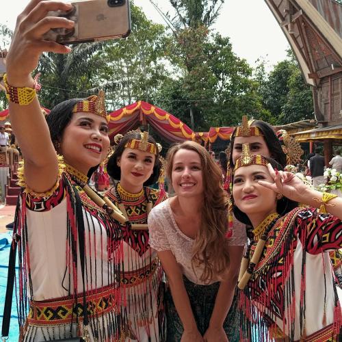 a group of girls in traditional costumes taking a picture at a carnival at THE SINGKI HOME FAMILY in Rantepao
