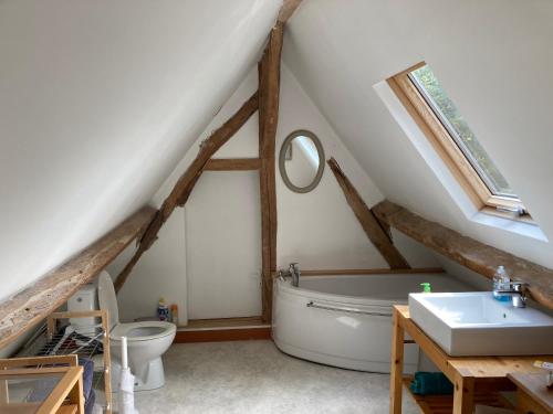 un baño con una bañera blanca y un lavabo en Proleps, en Varengeville-sur-Mer