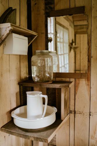 une étagère avec une tasse et une assiette dessus dans l'établissement Les cabanes de roquehort, à Salies-de-Béarn
