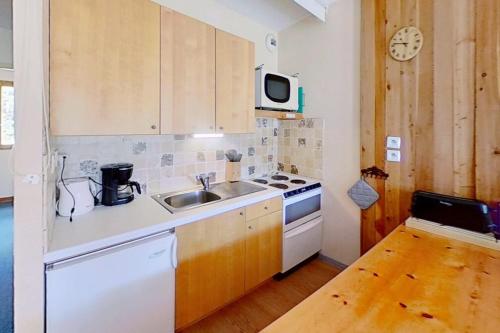 a small kitchen with a sink and a stove at CASA-Joubarbe 4p terrace in Arvieux in Arvieux