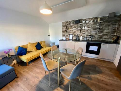 a living room with a couch and a glass table at The Roadshed Apartments @ Rohans Farm in Midleton