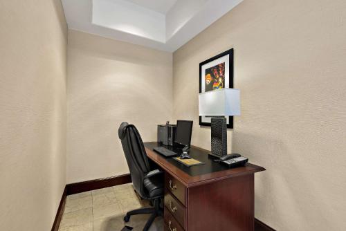 a room with a desk with a computer and a chair at Comfort Inn & Suites Airport Convention Center in Reno
