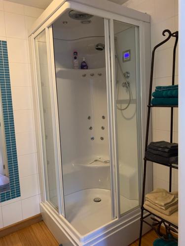 a shower with a glass enclosure in a bathroom at Le Jardin d'Isa in Chaumont-Gistoux