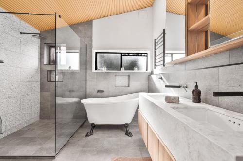 a bathroom with a tub and a sink at Shed House Lux Farm Stay in Buninyong