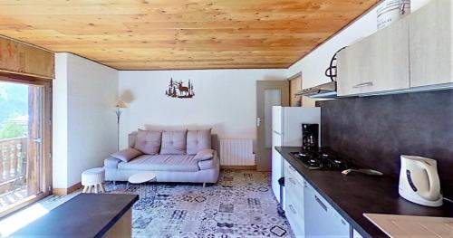 a living room with a couch in a kitchen at CASA-La Lobio foot of the slopes breathtaking views 4p in Saint-Véran