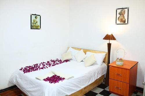 a bedroom with a bed with purple flowers on it at Kind private room 8 in Addis Ababa