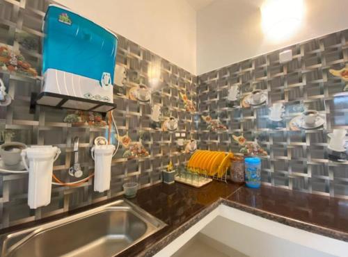 a kitchen with a sink and a counter top at Le Poshe Luxury Pondicherry in Puducherry