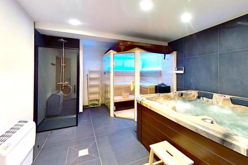 a large bathroom with a tub and a shower at CASA-Le Cherk Chalet 300m2 jacuzzi sauna Vars les Claux in Vars