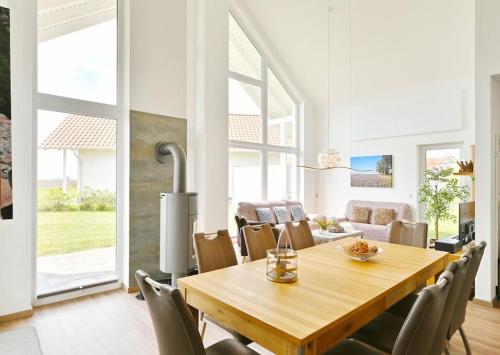 a dining room with a wooden table and chairs at Villa Meereszeit in Trent