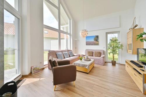 a living room with a couch and a table at Villa Meereszeit in Trent